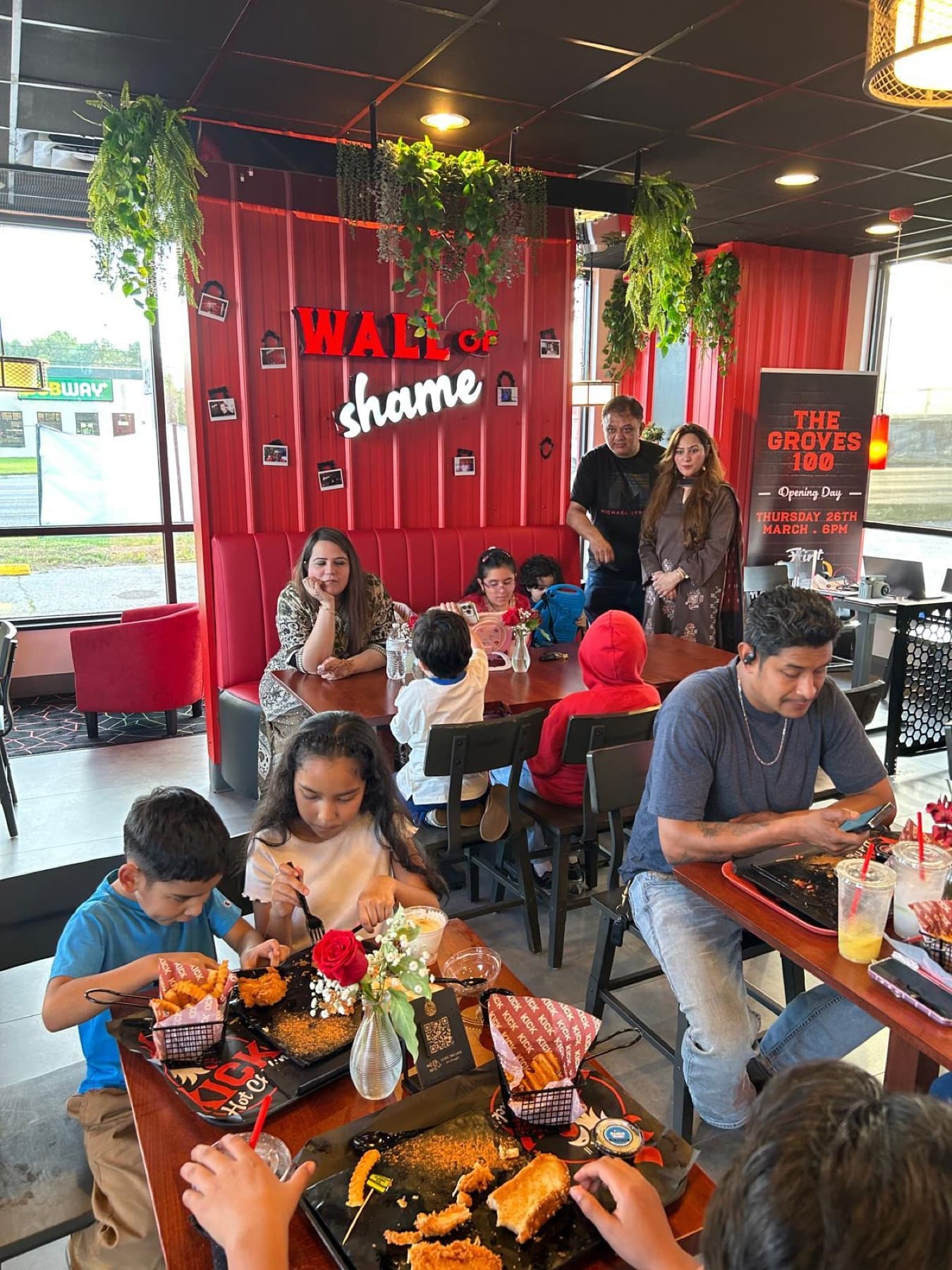 Families sharing a meal at Kwik Hot Chicken in Groves, Texas